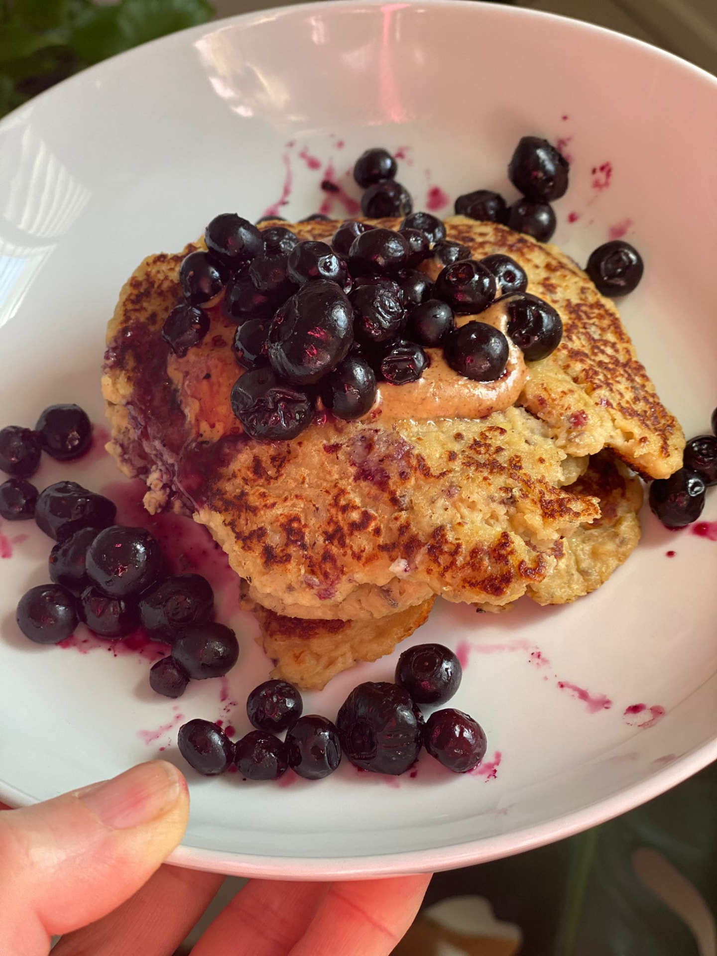 Protein pancakes topped with fresh blueberries and nut butter